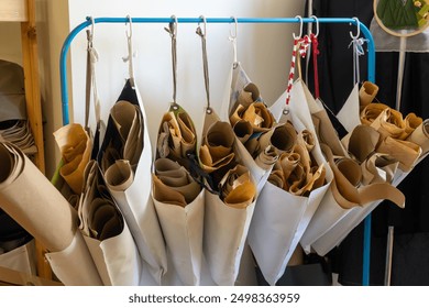 n a fashion designer's studio, rolls of paper patterns are neatly organized for efficient storage and easy access.   - Powered by Shutterstock