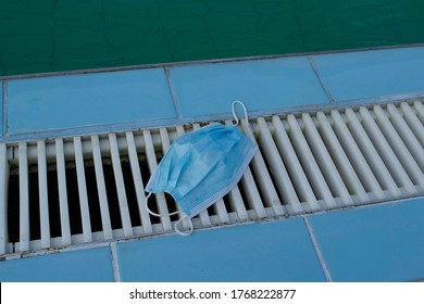 N95 Face Mask Thrown Away On The Side Of A Public Swimming Pool Due To Reopening Of Spa And Beach Leisure Complex After Corona Virus Pandemic Lockdown