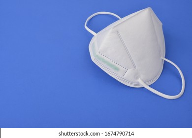  A N95 Mask On A Blue Background, Concept Of Covid-19