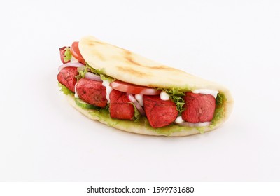 naan bread wrap sandwich paprika tandoori with onion and tomato, lettuce isolated on white background