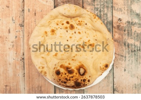 Naan: A substantial flatbread, practically baked in a tandoor, 