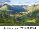 The Nab, Rest Dodd, Brock Crags and Heck Crag in warm sunlight above Bannerdale Beck in Martindale in the English Lake District, England, UK.