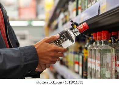 NABEREZHNYE CHELNY, RUSSIA - July 28, 2019: A Man Takes Alcoholic Drinks From The Supermarket Shelf. Shopping For Alcohol In The Store.