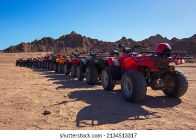 Nabq, Egypt - 12.22.2021: ATVs On Egyptian Sand Desert Near Mountains. Quad Bike In Nabq Protected Area, Sharm El Sheikh, Sinai, Egypt. Safari, Egyptian Excursion, Off-road ATV Adventures In A Desert