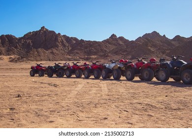 Nabq, Egypt - 12.22.2021: ATVs On Egyptian Sand Desert Near Mountains. Quad Bike In Nabq Area, Sharm El Sheikh, Sinai, Egypt, North Africa. Egyptian Excursion, Off-road ATV Adventures In A Desert