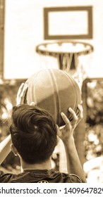 Nabua, Philippines- May 28, 2019: An Aspiring Basketball Player Is Practicing Hard Shooting The Ball On A Small Court At His Home Made By His Father For Him.