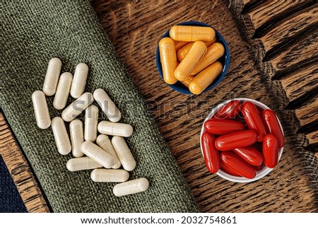 n-acetyl cysteine (NAC) and glutathione complex dietary supplements capsules and ubiquinol (coQ10) coenzyme q10 supplement softgels top view. immune prevention care concept