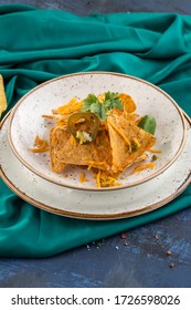 Nacho Chips With Cheese And Jalapeno On White Plate On Turquoise Background Side View