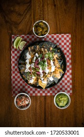 Nacho Platter From Above With Guacamole, Jalapeños, And Homemade Salsa