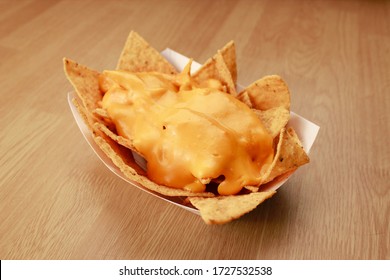 Nachos with cheese in disposable container