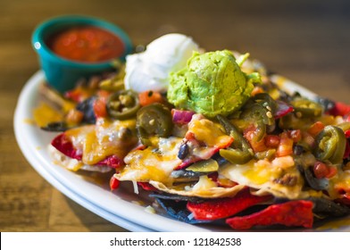 Nachos with cheese, guacamole, and sour cream