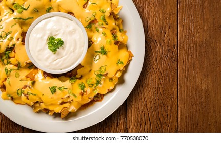 Nachos Chips With Cheddar Cheese And Dips Variety In The Plate.