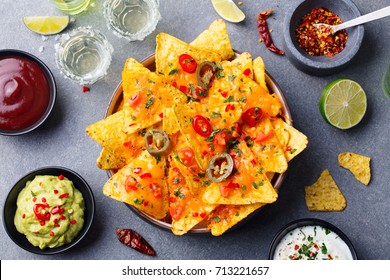 Nachos Chips With Melted Cheese And Dips Variety In Black Bowl. Top View.