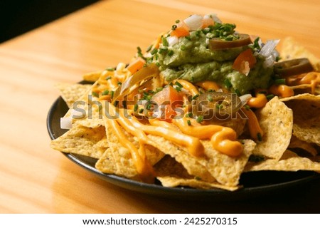 Nachos with guacamole and vegetables. Original Mexican recipe.