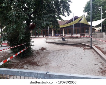 Nackenheim, June 15, 2020: Closed Playground At A Daycare Center. Due To The Pandemic Or Corona, Children Are Prohibited From Playing In The Playground. This Area Is Cordoned Off With Barrier Tapes.