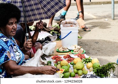 Nadi / Fiji Islands-January 10 2019: Afro Woman Covers With An Umbrella On The Market