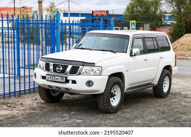 Nadym, Russia - August 13, 2022: White Offroad Car Nissan Patrol In The City Street.