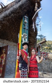 Naga tribesman and a Naga Tribeswomen dressed in traditional attire with traditional weapons at Kohima Nagaland India on 1 December 2016