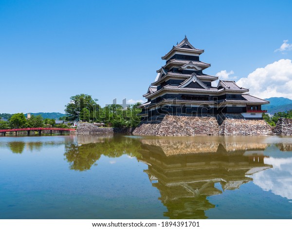 Nagano Prefecture, Japan: The\
beautiful historic castle of Matsumoto reflecting on the\
water