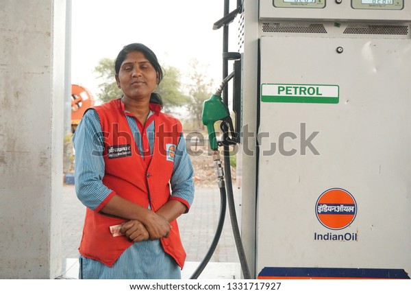 NAGPUR, MAHARASHTRA, INDIA - 04 MARCH 2019:
Unidentified Indian Woman pumping gasoline fuel at gas station.
Concept of Women empowerment .
