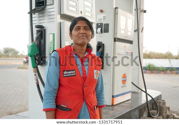 NAGPUR, MAHARASHTRA, INDIA - 04 MARCH 2019:\
Unidentified Indian Woman pumping gasoline fuel at gas station.\
Concept of Women empowerment .\
