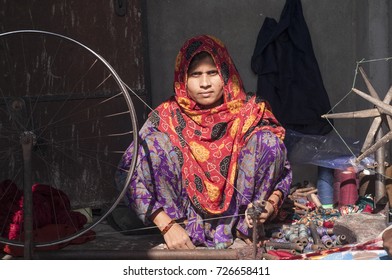 NAGPUR, MAHARASHTRA, INDIA 4 DECEMBER 2016 : Unidentified Indian woman weavers Removing knots of silk yarn and make ready for weaving sari on loom. Nagpur is famous for hand woven traditional sarees.