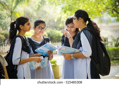 NAGPUR, MAHARASHTRA, INDIA, 9 APRIL 2016 : unidentified group of young girl university girl students talking together about their studies project at university campus.