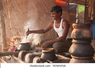 NAGPUR, MAHARASHTRA, INDIA, 9 JANUARY 2017 : Unidentified Man Making And Cooking / Baking Fresh Roti In A Rural Village In Vintage Kitchen Using Firewood In Earthen Chulhas.