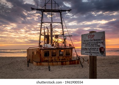 Nags Head, North Carolina, USA - April 18, 2021 - Beached Shipwreck Of The Ocean Pursuit Onto The North Carolina Outer Banks Coast Near Oregon Inlet With Sign From From The National Park Service