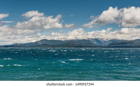Nahuel Huapi lake, San Carlos de Bariloche (Argentina). Waves on the lake. Mountains with fresh snow surrounding the lake.