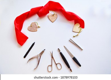 Nail accessories and hearts for Valentine's Day. Purchase of manicure products. manicure set for February 14. Visiting a beauty salon during the holidays. isolated on a white background