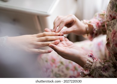 Nail Artist Applying Fake Nails In The Hands Of A Gentle Woman, Deft Of Field, Blur Background