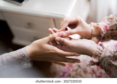 Nail Artist Applying Fake Nails In The Hands Of A Gentle Woman, Deft Of Field, Blur Background