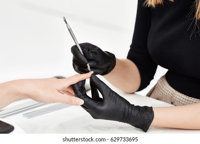 Nail Artist Making Manicure At Salon. Using Manicure Tools.