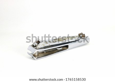 The nail clippers are made of silver steel that has traces through usage and placed on a white background.