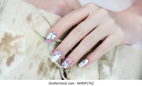 Nail design . Manicure nail paint . beautiful female hand with colorful nail art design manicure
