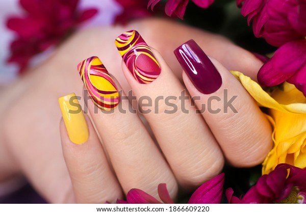 Nail design on\
shiny and matte nail Polish with smooth curves.Fashionable\
multicolored manicure.