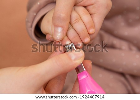 nail and finger manicure for baby by hand mom hold small scissor to cut nail for clean with love and care