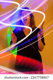 Nail manicurist photo content in neon light  Portrait manicurist holding manicure files in her hands 