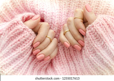 Nail Polish. Art Manicure. Modern style pink Nail Polish.Stylish pastel Color pink Nails holding wool material sleeve blouse . Classic wedding bride nails design - Powered by Shutterstock