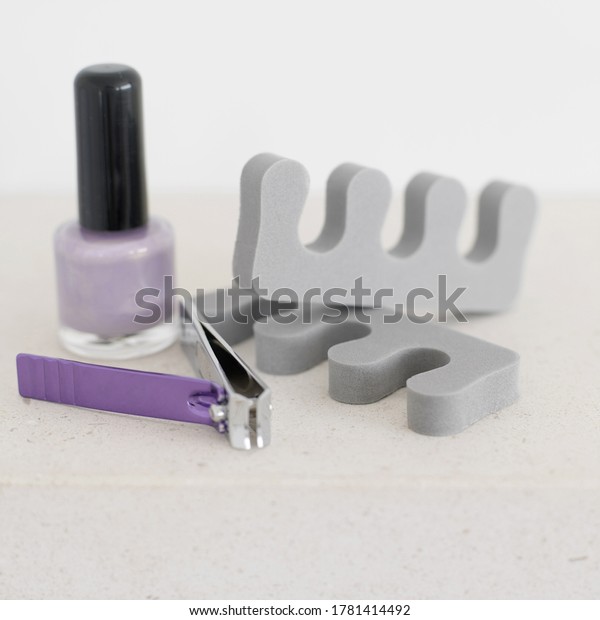 Nail polish, nail clipper and toe dividers.\
Conceptual image