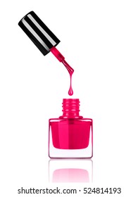 Nail polish dripping from brush into bottle on white background
