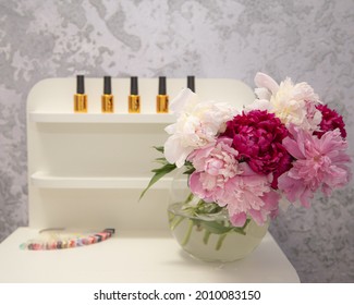 Nail Salon Cabinet Interior. Elegant Peony Flowers In Vase On White Manicurist Table. No People.