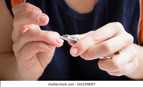 Nail Salon. Closeup Of Female Hand With Healthy Natural Nails Getting Nail Care Procedure. Closeup Hands Removing Cuticles With Professional Nail Tool, Metal Clippers. Beauty Manicure. High Resolution - Shutterstock ID 1015398097