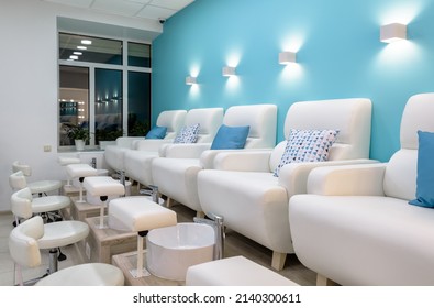 Nail Salon Interior, Modern Pedicure Armchairs In Manicure Shop Or Spa Room. Inside Bright Beauty Studio With Blue And White Design. Clean Empty Trendy Pedicure Salon. Moscow - Feb 7, 2019