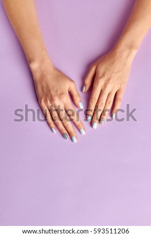 Nail salon. Skin care and spa concept. Beautiful female hands with manicured nails. Space for text.