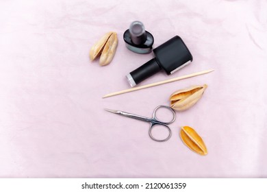 Nail Salon Table With Manicure Tools And Nail Polish Bottles On Pink Background. Flat Lay, Top View.  Beauty Treatment Concept