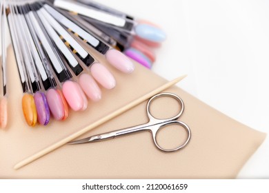 Nail Salon Table With Manicure Tools And Nail Polish Bottles On Green Background.  Beauty Treatment Concept