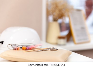 Nail Salon Table With Manicure Tools And Nail Polish Bottles On Green Background.  Beauty Treatment Concept