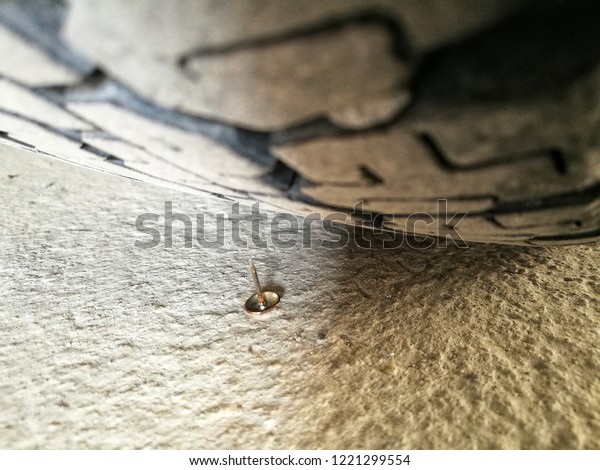 The nail stung the black rubber\
tire of the old car it is a part of the wheel that has\
damage.